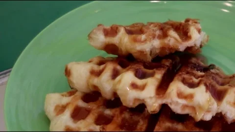 Croffle which is a sweet snack served on a green plate Stock Footage 231274160