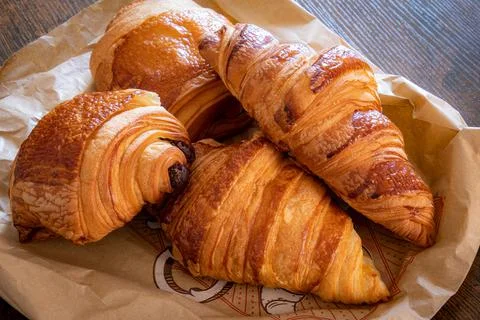 Croissant and chocolate bread on a table 스톡 사진