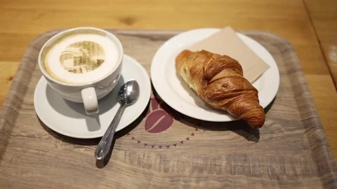 Croissant and coffee on the table in a coffee shop Stock Footage 297198369