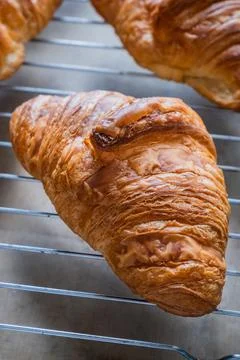 Croissant on baking rack Stock Photos