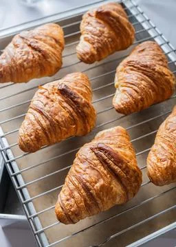Croissant on baking rack Stock Photos