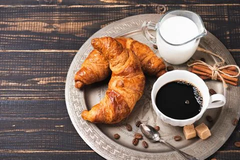 Croissant with chocolate hazelnut spread and cup of coffee Stock Photos