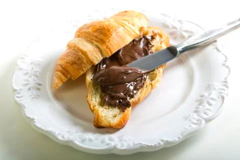Croissant with chocolate paste. Stock Photos