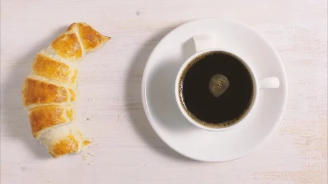 Croissant with a cup of coffee. Stop motion, animation Stock Footage 73572692