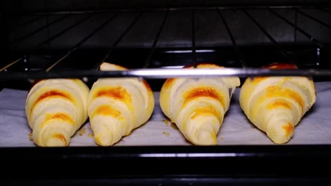 Croissant dough with egg applied to it to be put in the oven Stock Footage 289014280
