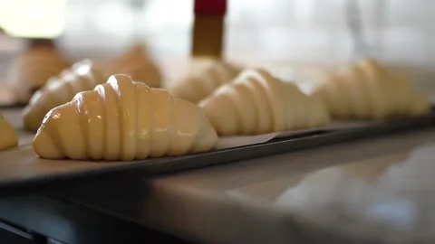 Croissant dough is prepared with eggs before going into the oven. Stock Footage 181006945
