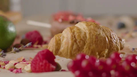 Croissant falls in kitchen table. Slow mo Stock Footage 168813073