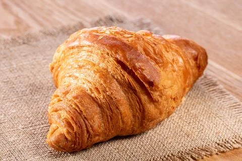 Croissant on the kitchen table, top view, close-up Stock Photos