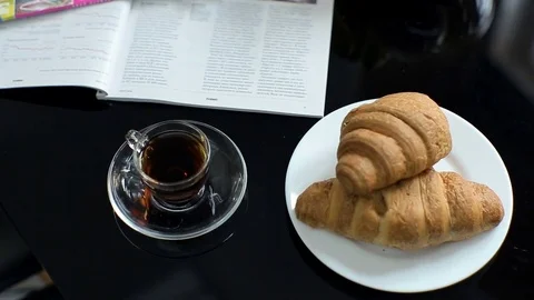 Croissants and coffee on the table in the kitchen Stock Footage 73751178