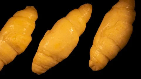 Croissants baking timelapse, black background Stock Footage 105395025