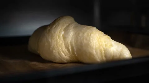 Croissants baking timelapse. One hand made croissants cooking Stock Footage 164379592
