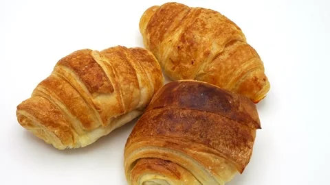Croissants on white background Rotated. Vídeo Stock 265529285