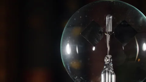 Crookes Radiometer Light Mill with Gold Reflections on Bookshelf, Right Align Stock Footage 331100974