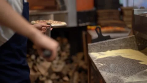 Crop anonymous chef putting uncooked pizza into furnace Stock Footage 238813556