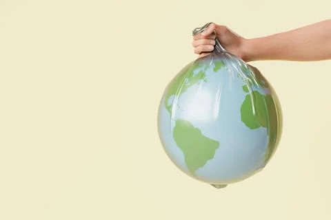Crop anonymous person showing plastic bag with globe Stock Illustration