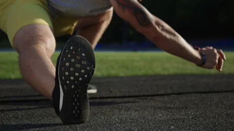 Crop athlete stretching on field Stock Footage 100557938