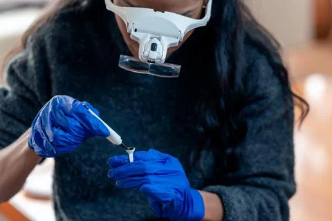 Crop black microblading master pouring ink for permanent makeup into ring Stock Photos