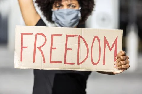 Crop black protester with Freedom inscription on placard on strike Stock Photos