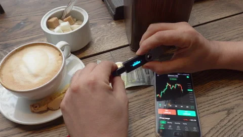 Crop broker using hardware wallet near smartphone Stock Footage 152994201