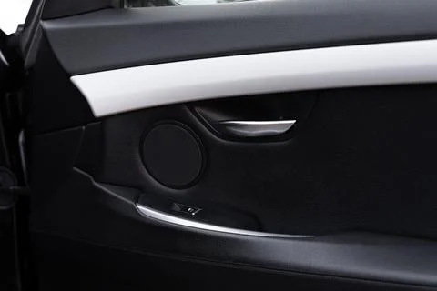 Crop of car door panel with array of technologically advanced switches and Foto stock