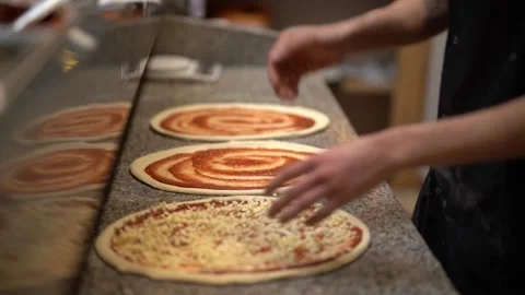 Crop chef decorating pizza with cheese Stock Footage 239526865