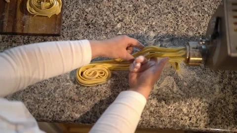 Crop chef making noodles using pasta machine Stock Footage 239512885