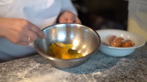 Crop chef mixing eggs in restaurant kitchen Stock Footage 239513093