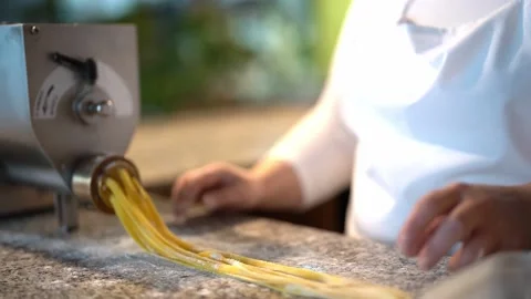 Crop chef preparing pasta noodles with pasta machine Stock Footage 239611068