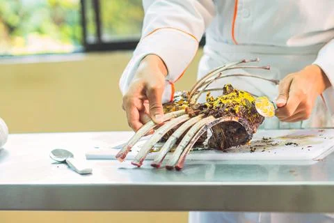 Crop chef preparing rack of lamb Stock Photos