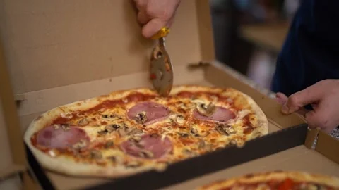 Crop chef slicing ham pizza in pizzeria Stock Footage 238813577
