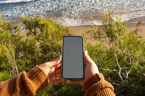 Crop child using smartphone over beach Stock Photos