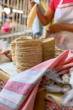 Crop cook and stacks of flatbreads at market stall Stock Photos