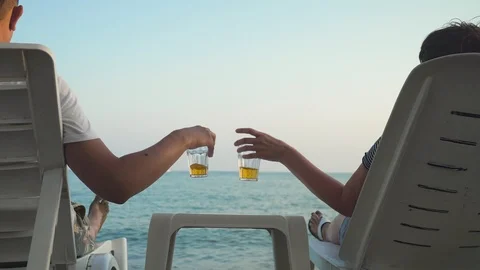 Crop couple clinking with drinks on beach Stock-Footage 93113779