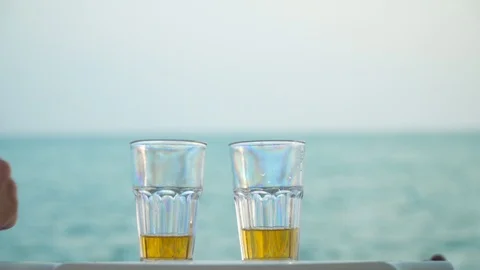 Crop couple clinking with drinks on beach Stock Footage 93113883