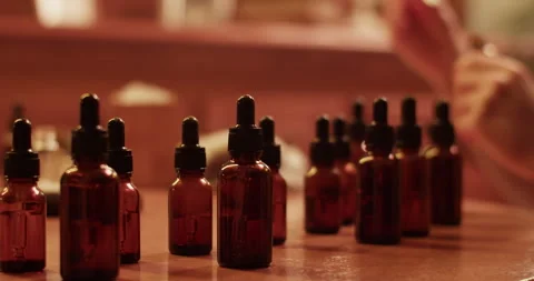 Crop craftsman mixing oils while making handmade perfume Stock Footage 260985775