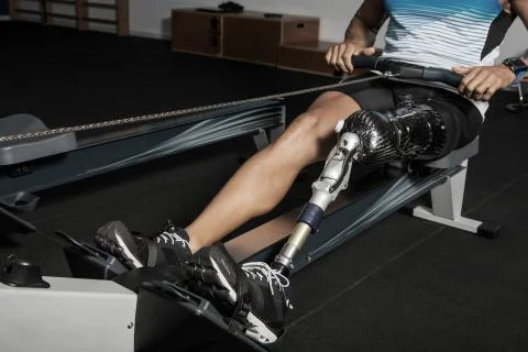 Crop disabled man on rowing machine Stock Photos