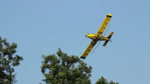 Crop duster flying low over roof Stock Footage 41866365