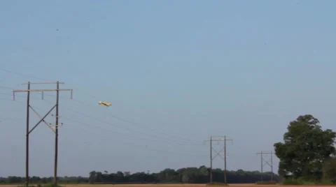 Crop duster flying low over camera in field Stock Footage 41866521