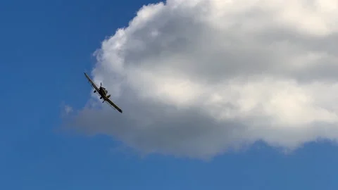 Crop duster plane in flight against blue sky Video stock 343571249
