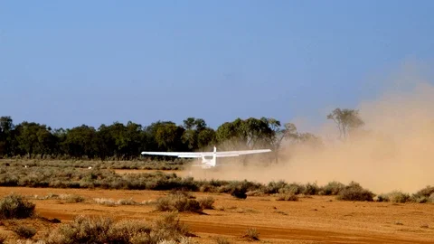 Crop-duster taking off from a field in order to spread fertilizer or Stock Footage 96411583