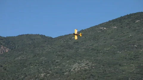 Crop duster yellow mountain turn P HD 1043 Stock Footage 476059