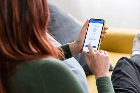 Crop faceless woman using smartphone sending money with online bank Stock Photos