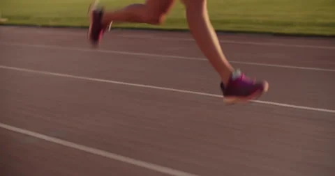 Crop female sprinter running fast on track during training Stock Footage 243627073