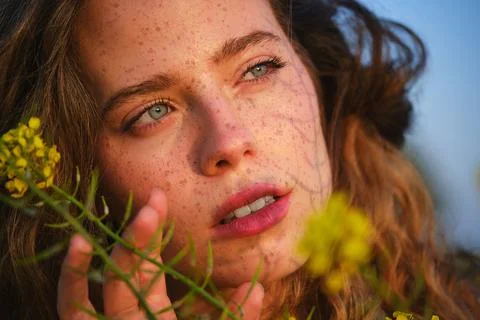 Crop gorgeous woman with delicate yellow flowers in nature 스톡 사진