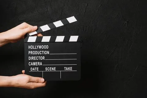 Crop hands clapping blank clapperboard. High quality photo Stock Photos