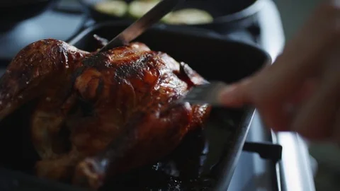 Crop hands cut cooked chicken in the oven Stock Footage 77560121