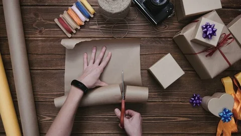 Crop hands cutting paper and wrapping present Stock-Footage 69928364