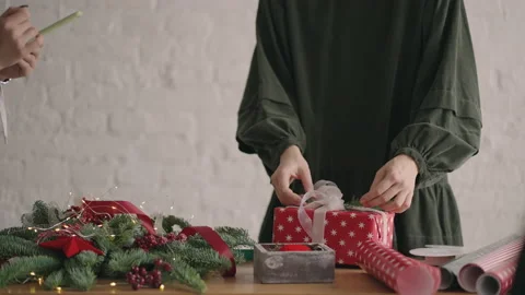 Crop hands decorating wrapped box with string. Female packing cardboard gift box Stock Footage 165641894