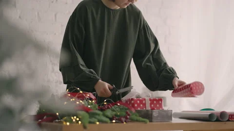 Crop hands decorating wrapped box with string. Female packing cardboard gift box Stock Footage 165642112
