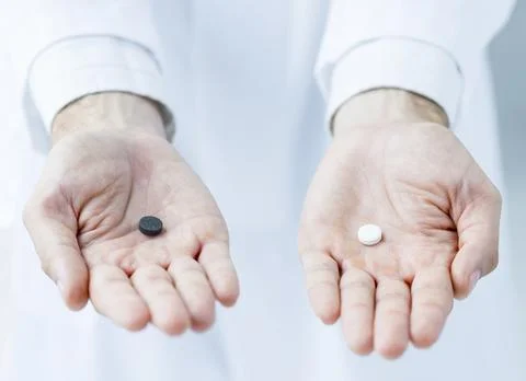 Crop hands offering two pills Stock Photos
